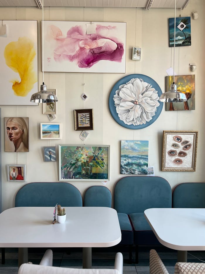 Elegant cafe interior with artistic wall decor and cozy seating.