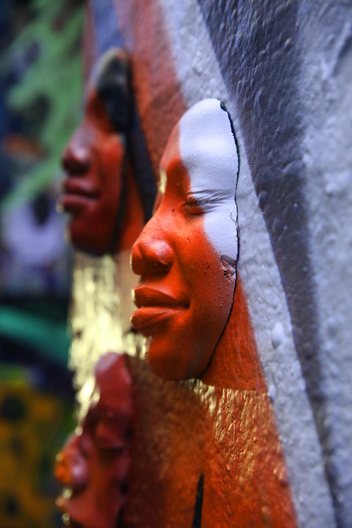 Detailed close-up of colorful street art faces in Melbourne's vibrant outdoor scene.