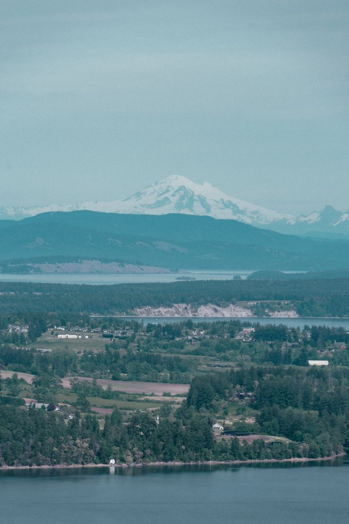 Panoramic landscape of Malahat, BC with majestic mountains and lush forest.